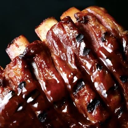 Sauced ribs stacked on a plate